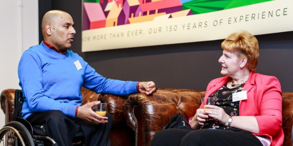 Image of a male and a female member in conversation at one of our in-person events, in discussion