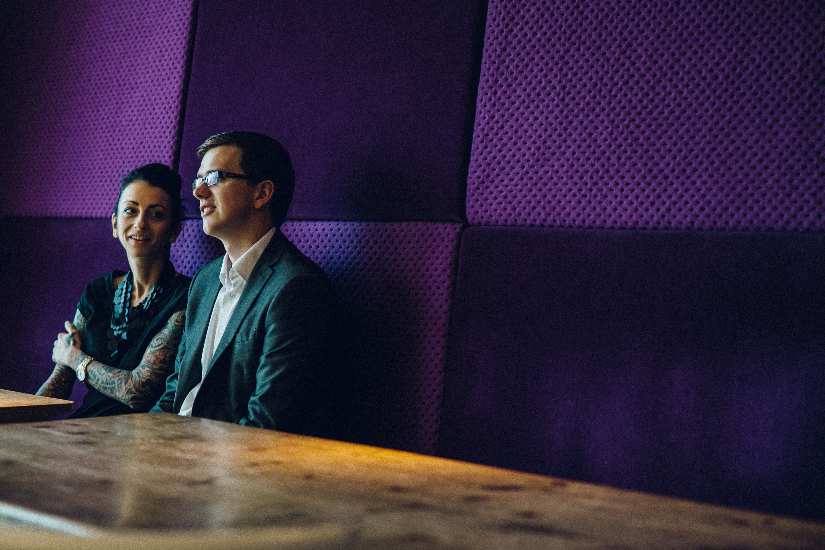 Image shows a male and female attendee at a PurpleSpace in person event, in conversation sat at a table